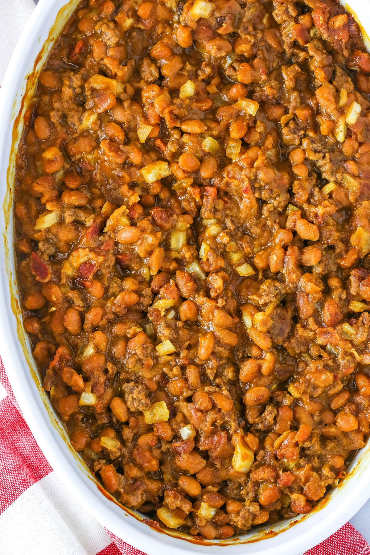 Overhead view of Mom's Amazing Baked Beans in a white serving dish