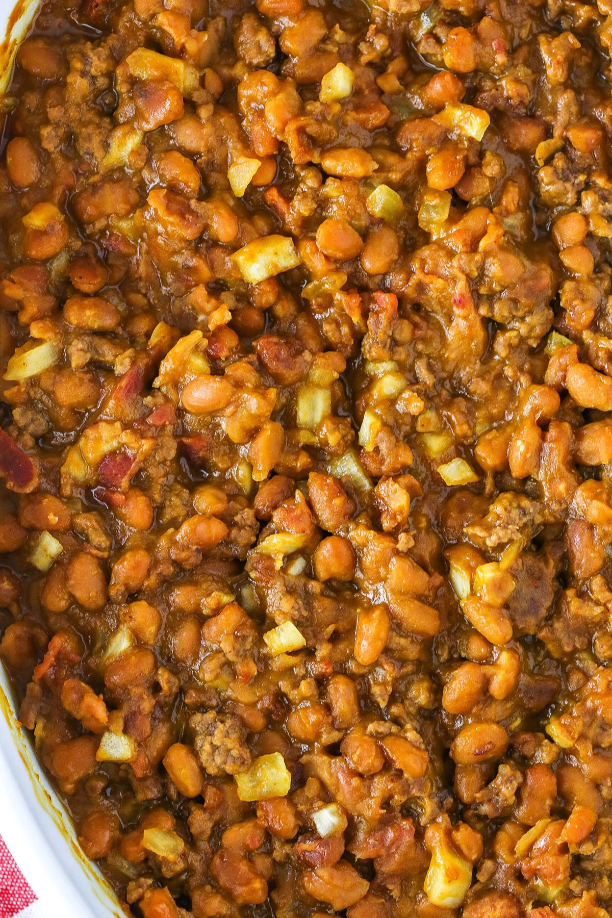 Overhead view of Mom's Amazing Baked Beans in a white serving dish