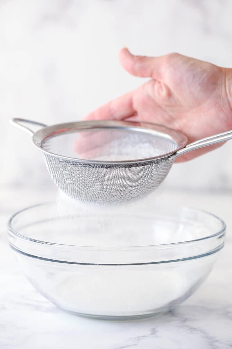 Sifting dry ingredients for cake batter.