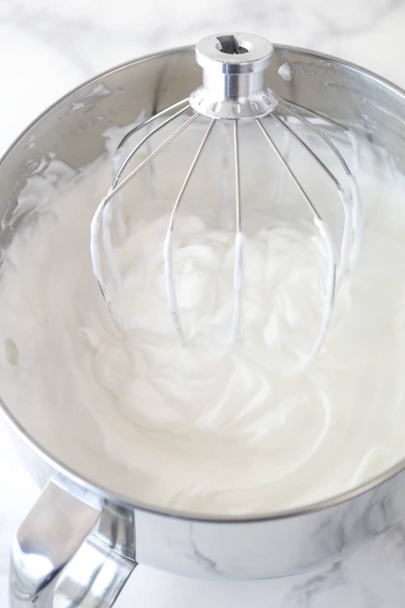 Egg whites whipped to stiff peaks with cream of tarter, vanilla extract, and sugar.