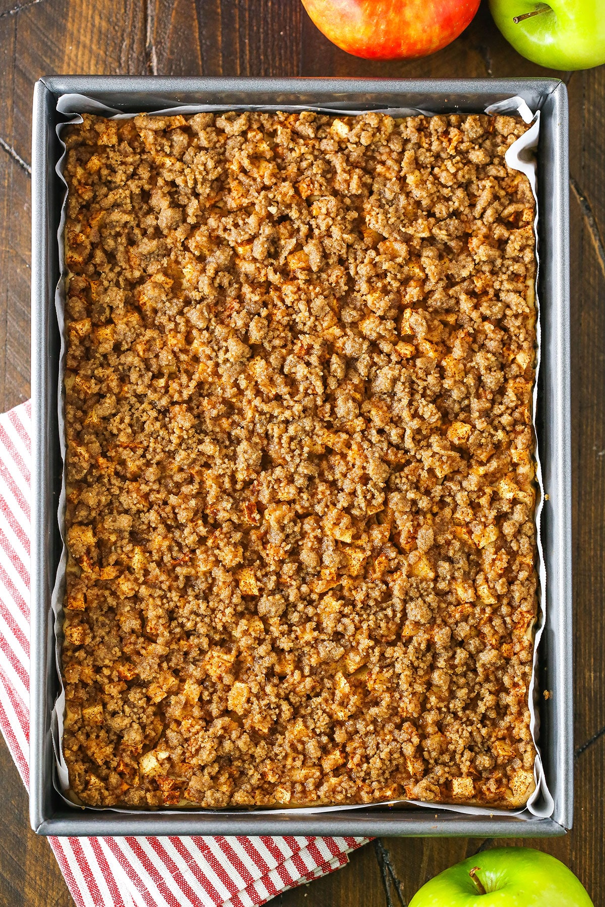 Overhead view of baked Apple Streusel Cheesecake Bars before being cut into individual bars in a baking pan