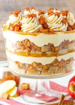 Side view of a full Caramel Apple Cheesecake Blondie Trifle in a glass trifle stand