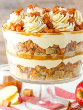 Side view of a full Caramel Apple Cheesecake Blondie Trifle in a glass trifle stand