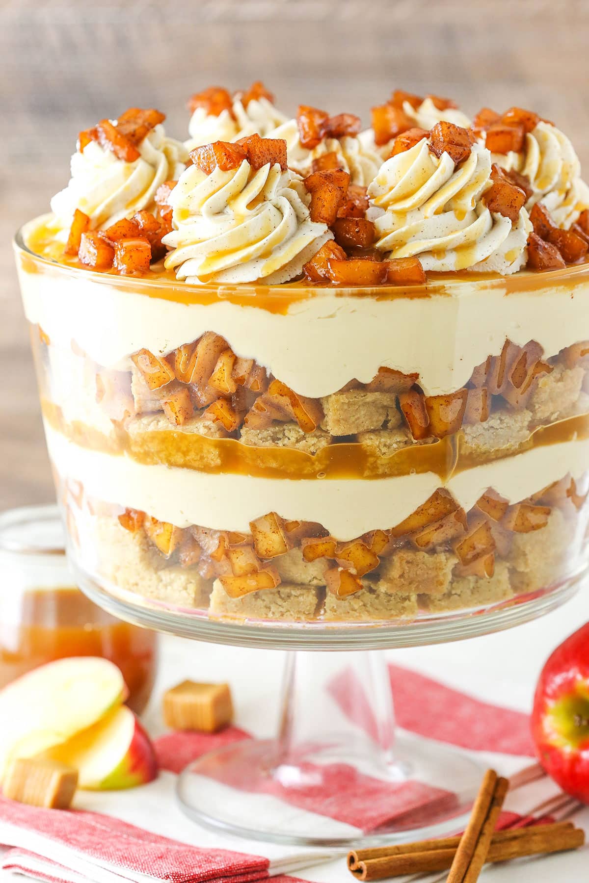 Side view of a full Caramel Apple Cheesecake Blondie Trifle in a glass trifle stand