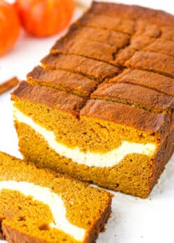 Side view of Cheesecake Swirl Pumpkin Bread sliced with the front slice removed