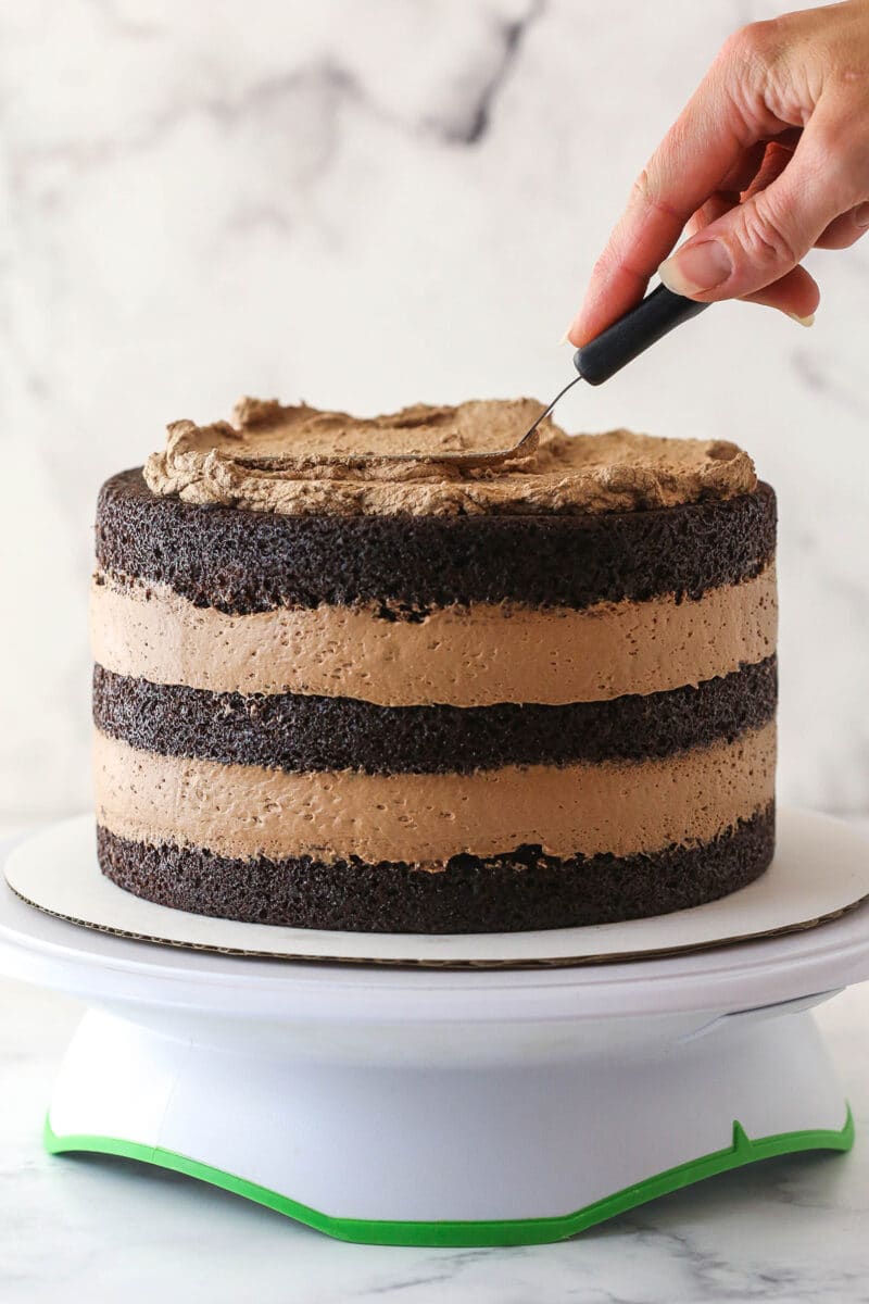 Frosting the top of chocolate mousse cake.