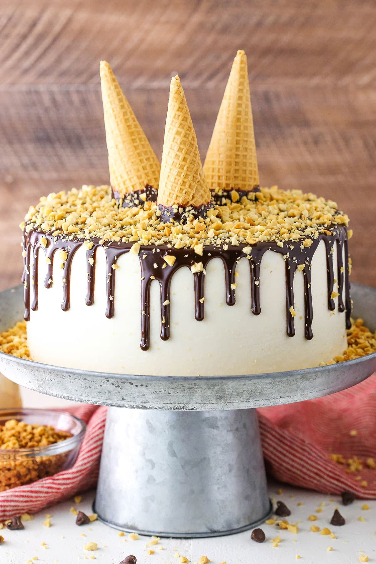 Side view of of a full Drumstick Layer Cake on a silver cake stand