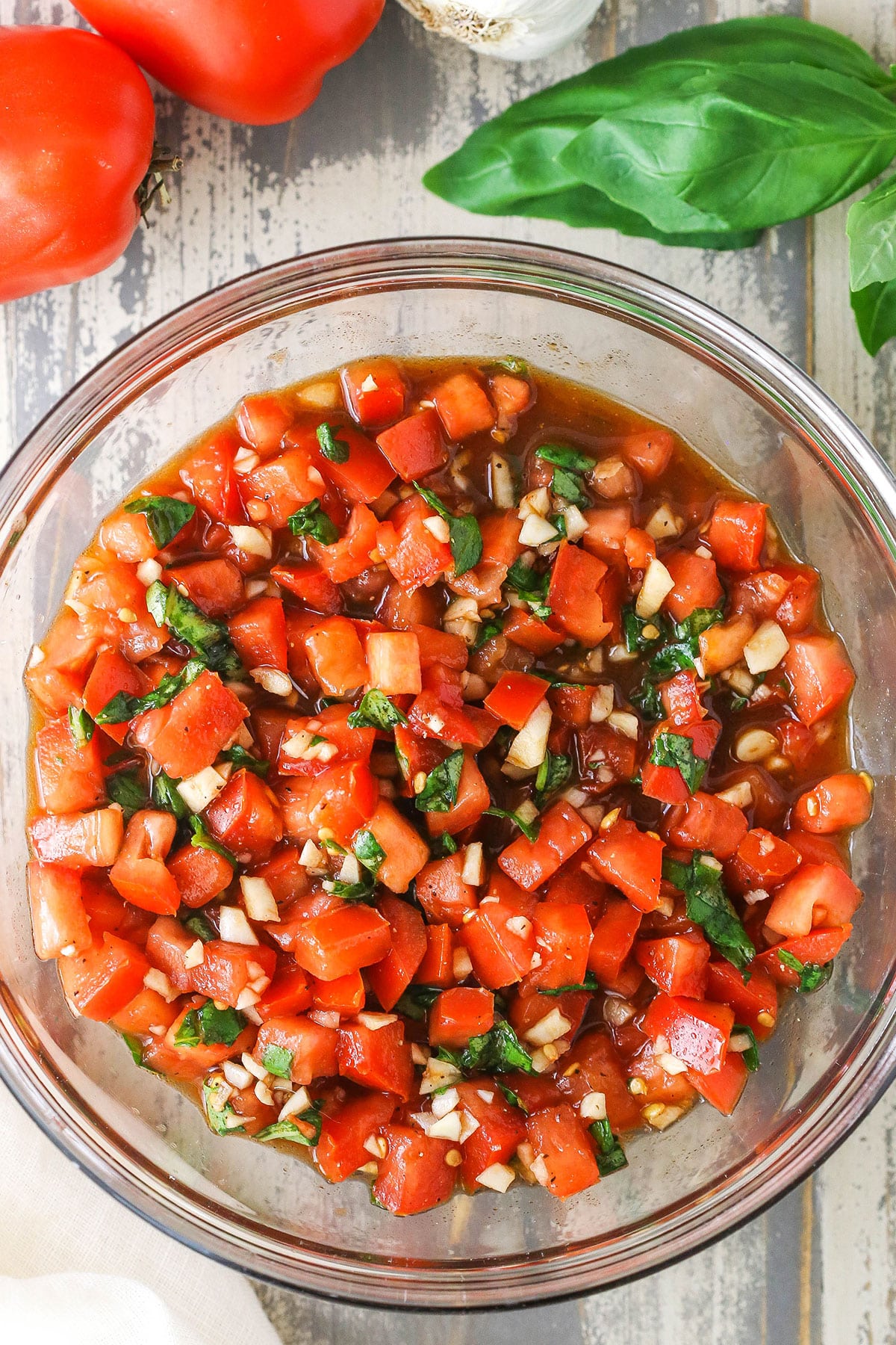 Overhead view of Bruschetta in a clear glass bowl