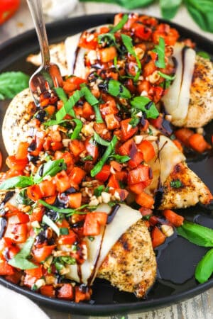 Bruschetta Chicken in a black pan