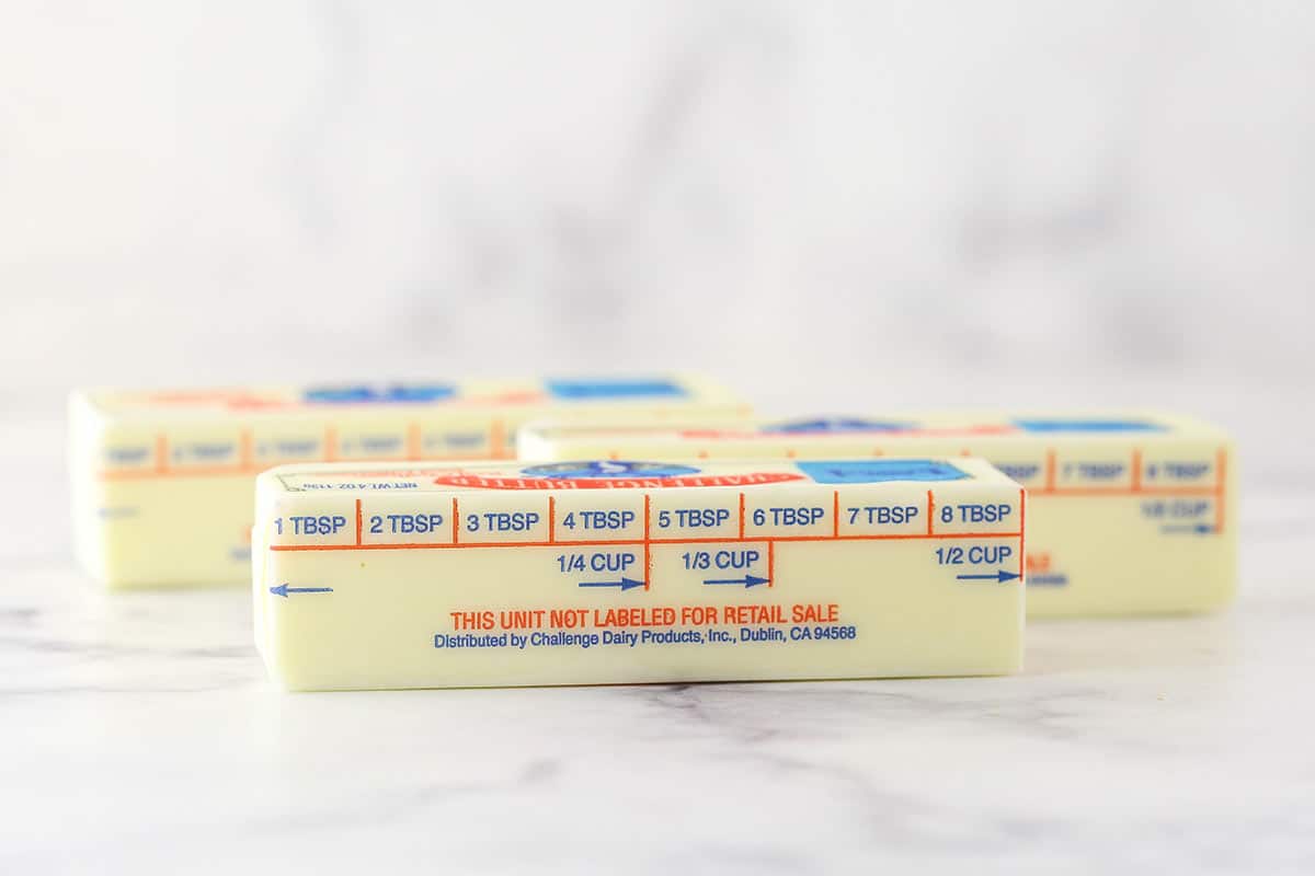 three sticks of butter sitting on countertop