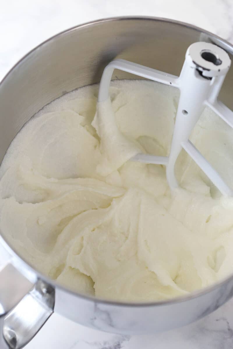 Creaming together butter, sugar, oil, and vanilla for cake batter.