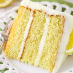A slice of lemon layer cake on a plate.