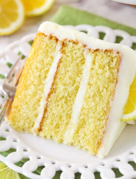 A slice of lemon layer cake on a plate.