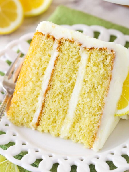 A slice of lemon layer cake on a plate.