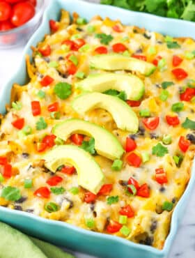 Mexican Chicken Casserole in a blue serving platter topped with slices of avocado