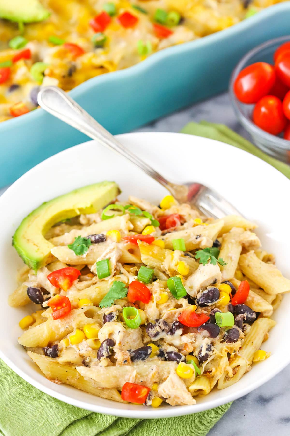 A serving of Mexican Chicken Casserole with a fork in a white bowl