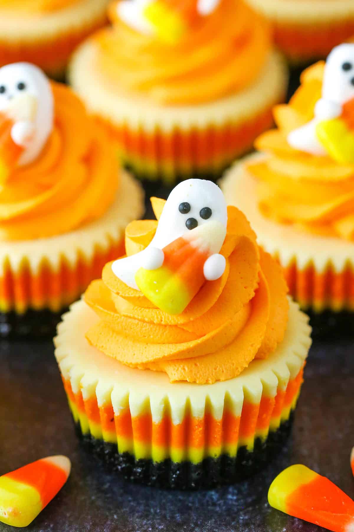 A Mini Candy Corn Cheesecake on a black table top