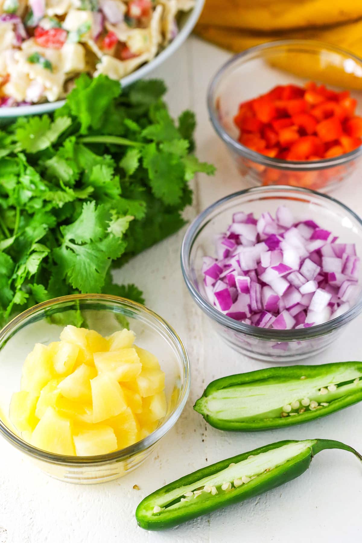 Pineapple Salsa Pasta Salad ingredients spread out over a white table