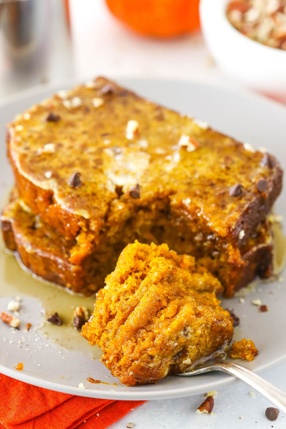 Two slices of Pumpkin Bread French Toast with a bite removed on a fork