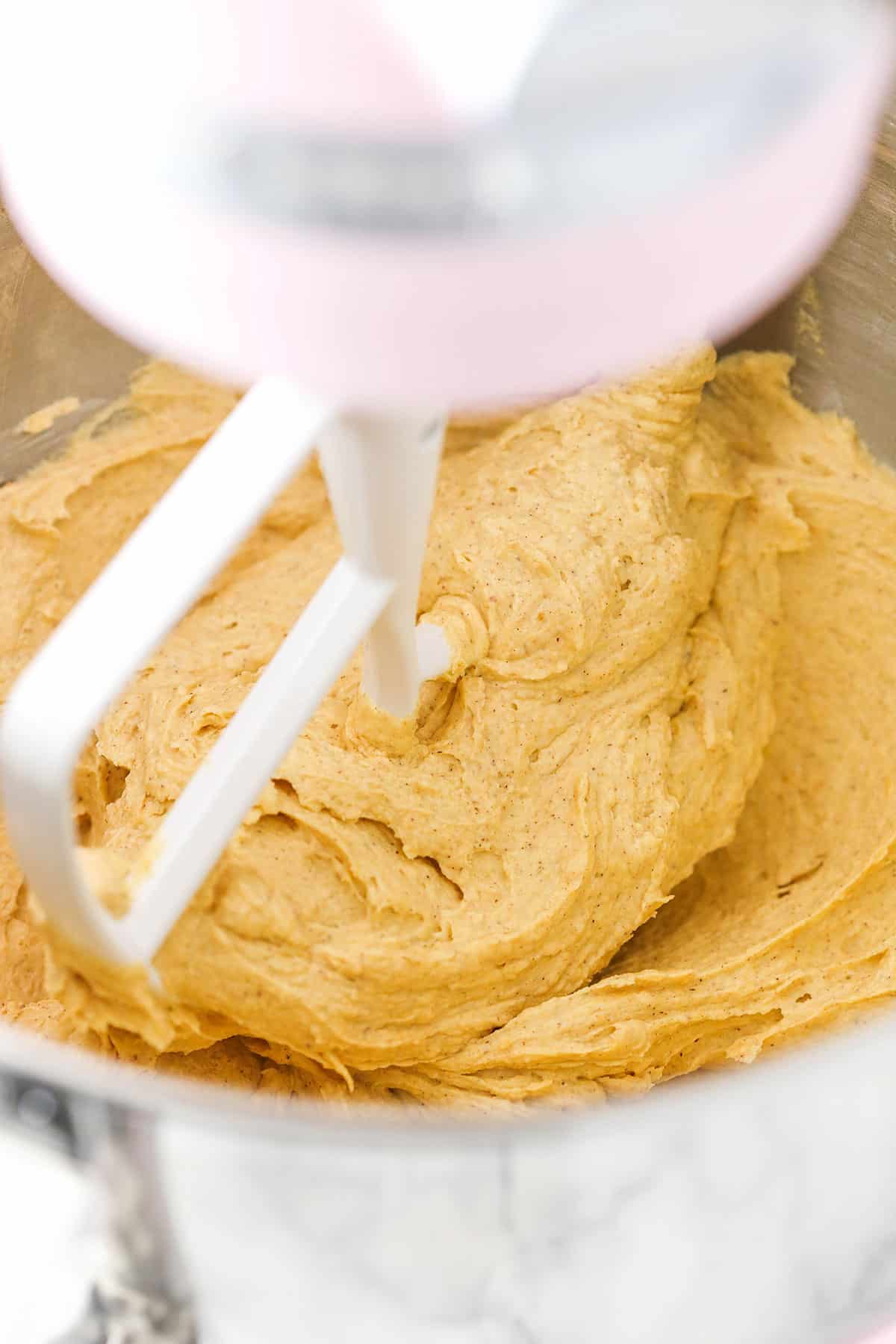 Pumpkin Spice Buttercream Frosting being mixed in a mixing bowl