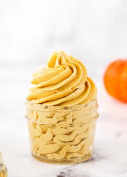 Pumpkin Spice Buttercream Frosting piped into a clear glass jar