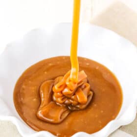 Pouring Salted Caramel Sauce into a white serving dish