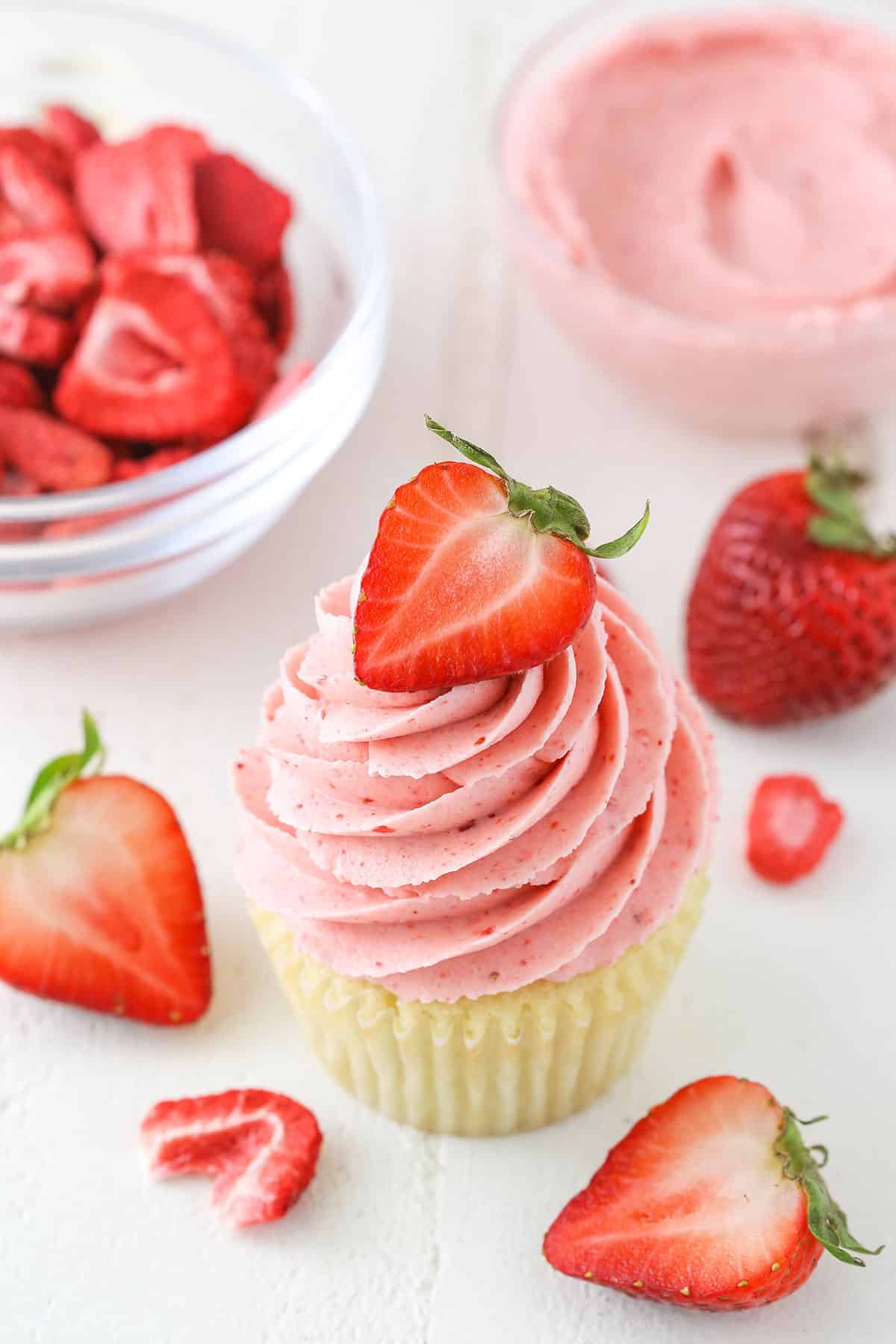 A vanilla cupcake with Homemade Strawberry Frosting piped on top