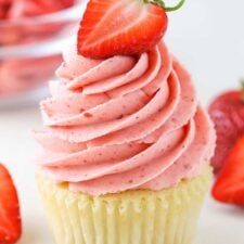A vanilla cupcake with Strawberry Frosting piped on top