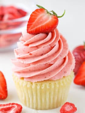 A vanilla cupcake with Homemade Strawberry Frosting piped on top