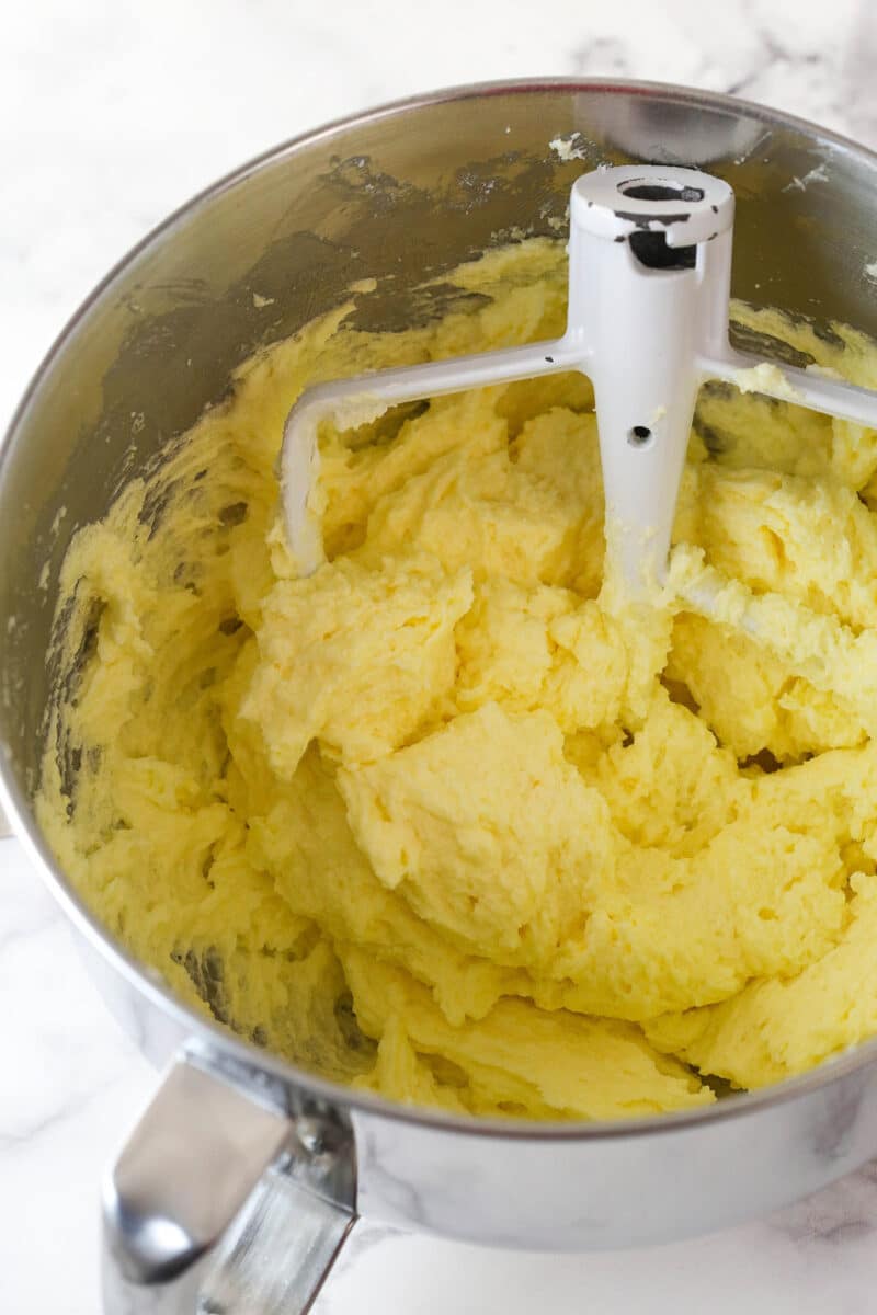 Adding eggs to pound cake batter.