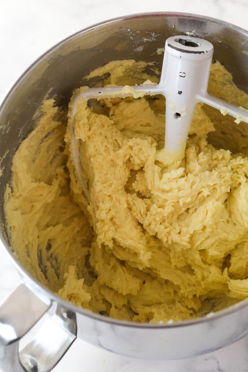 Adding dry ingredients to pound cake batter.