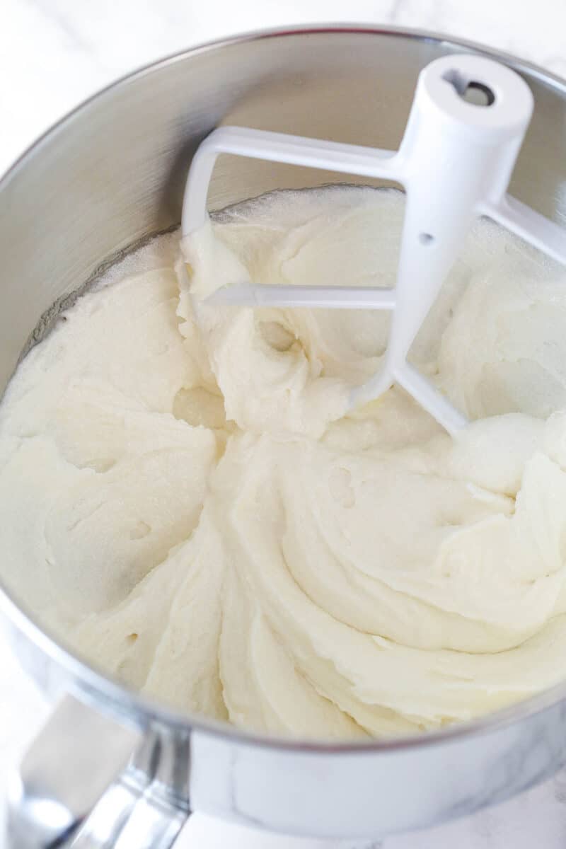Creaming together butter, oil, sugar, and vanilla extract for cake batter.