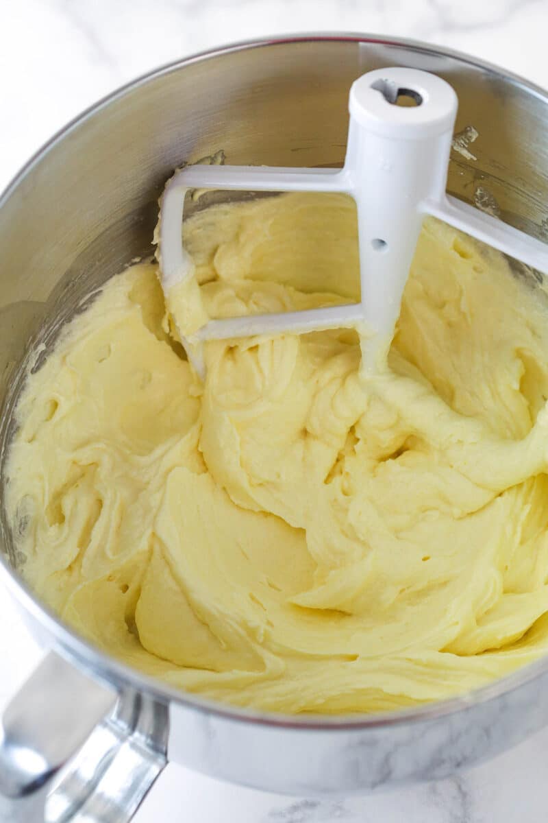 Adding eggs to vanilla cake batter.