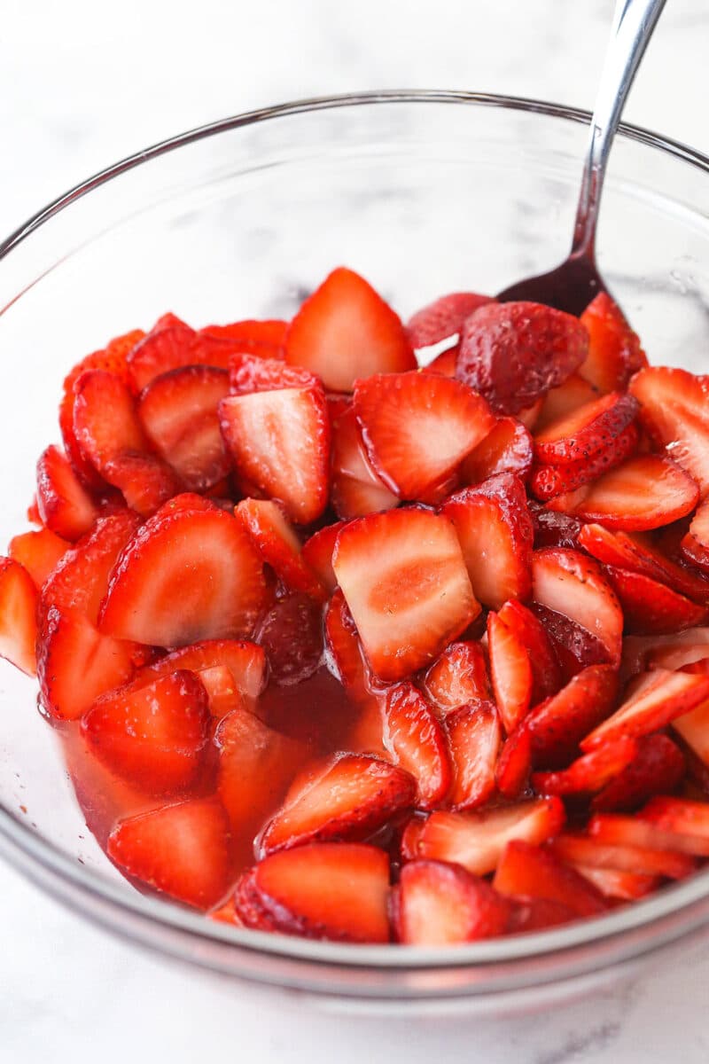 Strawberries in a mixing bowl after sitting in sugar for a couple of hours.