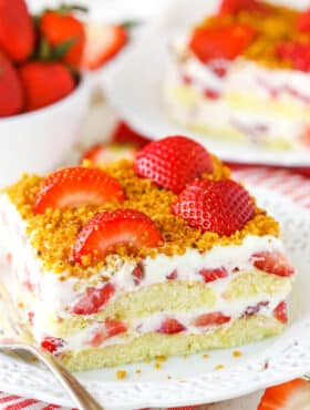 A serving of Strawberry Shortcake Icebox Cake next to a fork on a white plate