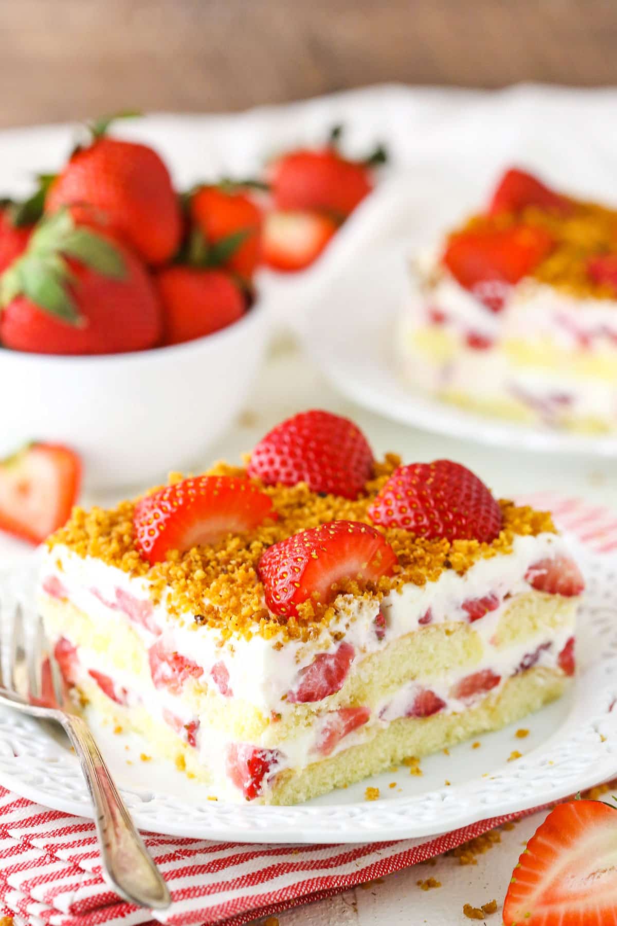 A serving of Strawberry Shortcake Icebox Cake next to a fork on a white plate