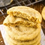 Closeup of brown sugar cookies stacked with the top cookie broken in half.
