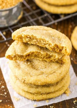 Closeup of brown sugar cookies stacked with the top cookie broken in half.