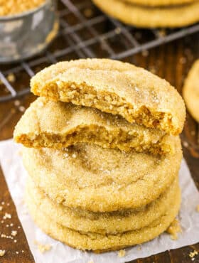 Closeup of brown sugar cookies stacked with the top cookie broken in half.