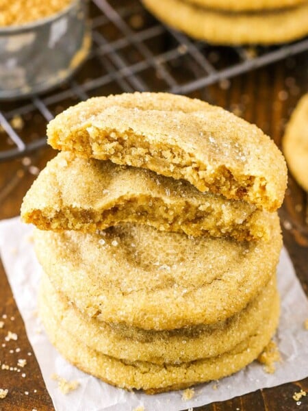Closeup of brown sugar cookies stacked with the top cookie broken in half.