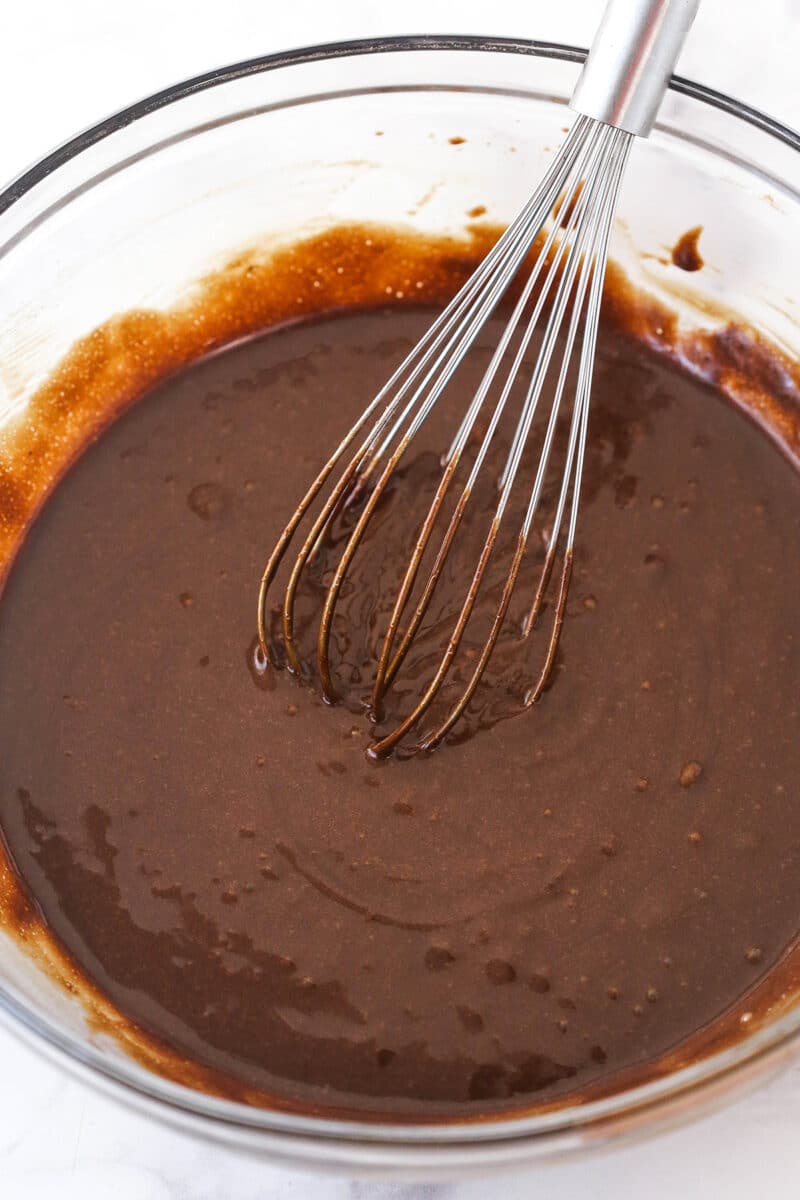 Whisking together wet and dry ingredients for cupcakes batter.