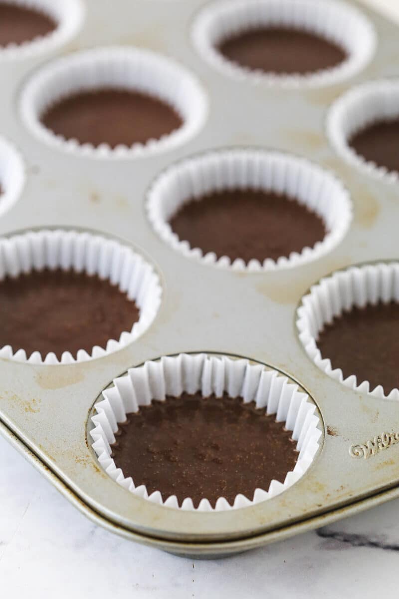 Cupcake liners filled with chocolate cupcake batter.