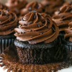 Pealing back the cupcake liner on a moist chocolate cupcake.