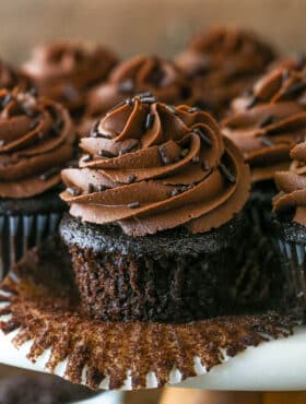 Pealing back the cupcake liner on a moist chocolate cupcake.