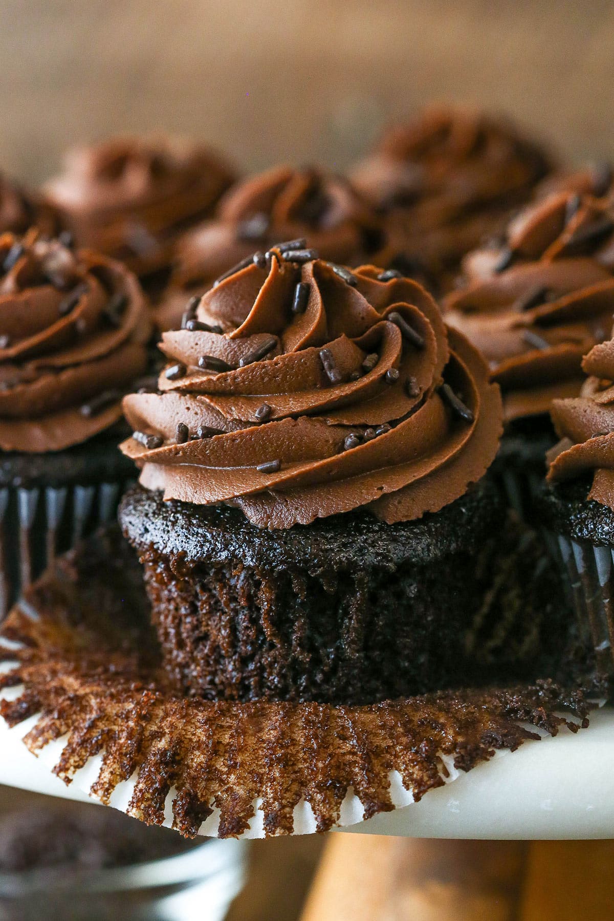 Pealing back the cupcake liner on a moist chocolate cupcake.