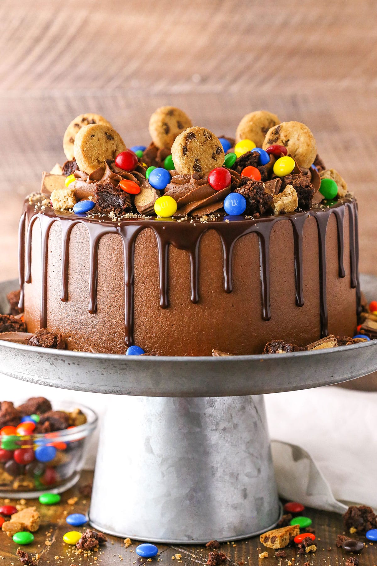 Side view of a Chocolate Piñata Cake on a gray cake stand