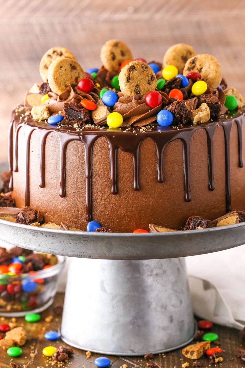 Side view of a Chocolate Piñata Cake on a gray cake stand