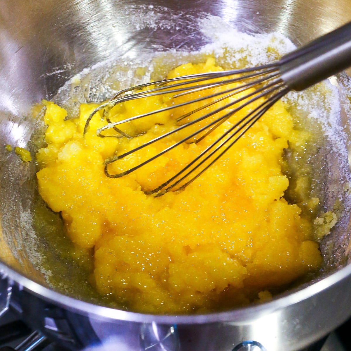 A step in making Easy Tiramisu combining the egg yolks and sugar in a mixing bowl