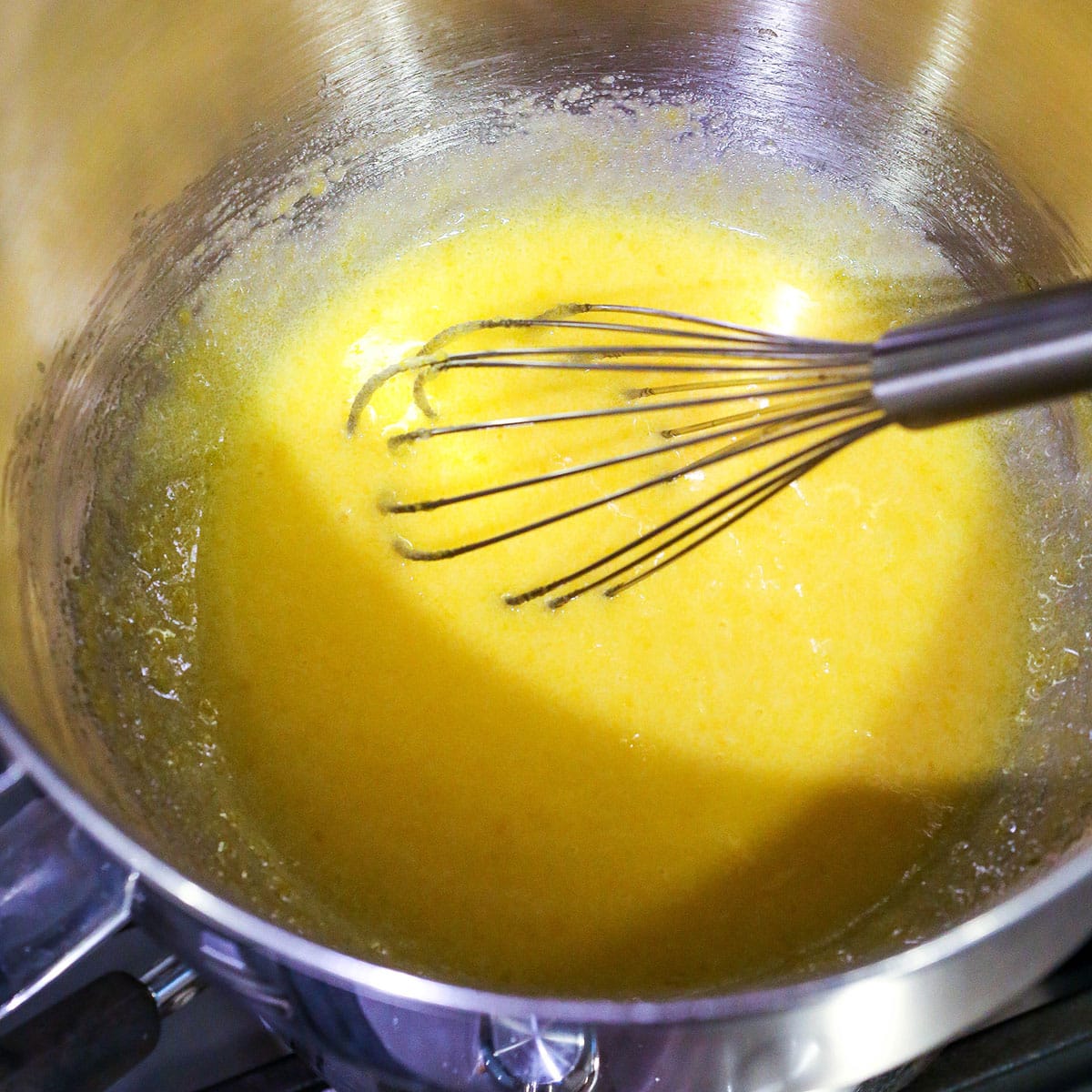 A step in making Easy Tiramisu showing the mixture thinning out as it heats up