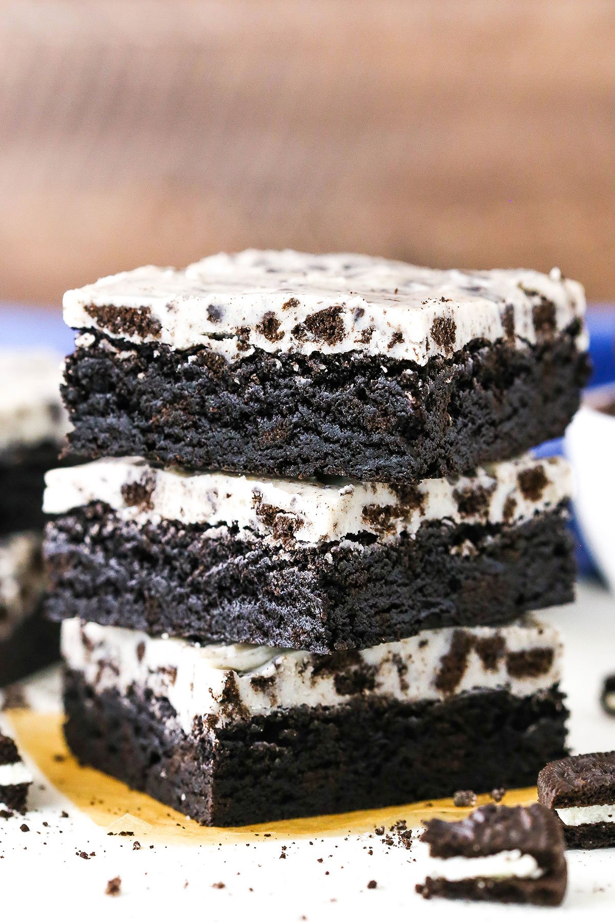 Three Fudgy Cookies and Cream Brownies stacked on a white table